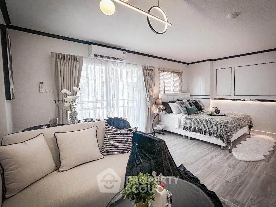 Stylish modern living room with cozy bedroom area and elegant decor