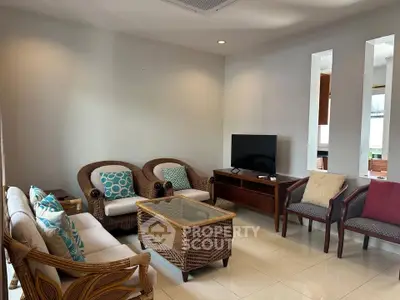 Spacious living room with elegant wicker furniture and modern decor