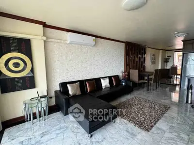 Stylish living room with modern decor and open dining area, featuring marble flooring and chic furnishings.