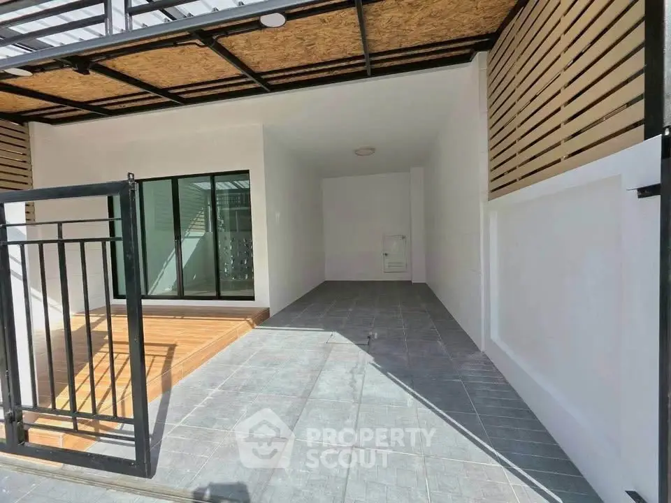 Modern townhouse entrance with sleek design and spacious parking area