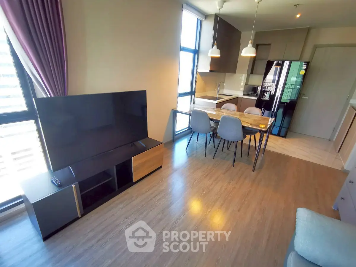 Modern open-plan living room with dining area and sleek kitchen