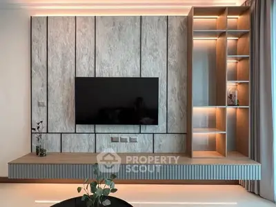 Modern living room with sleek TV wall unit and ambient lighting