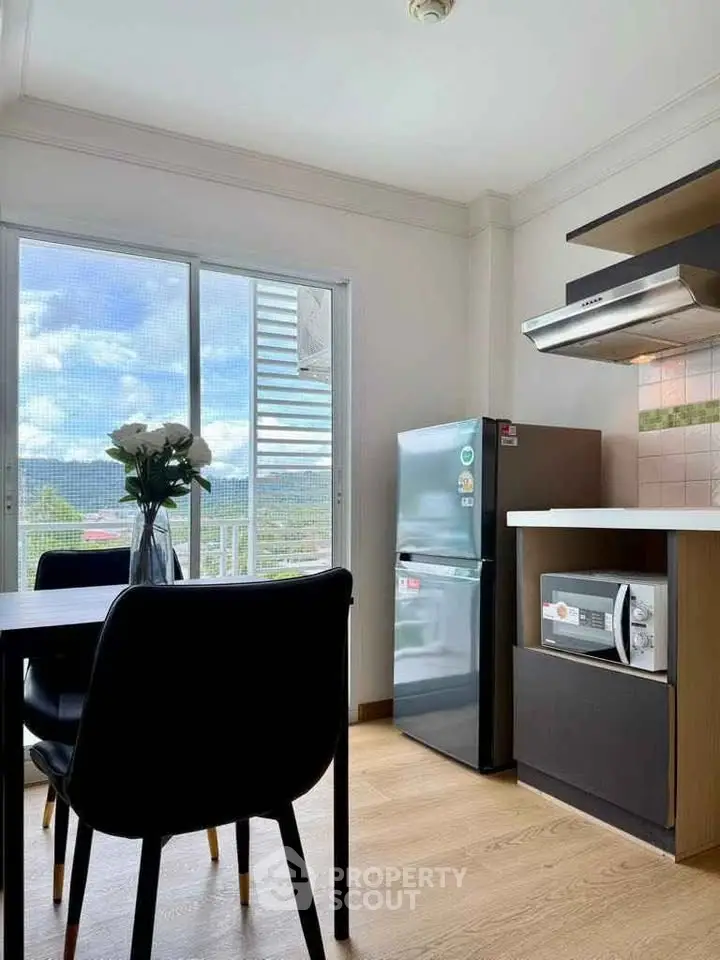 Modern kitchen with sleek appliances and scenic view from window