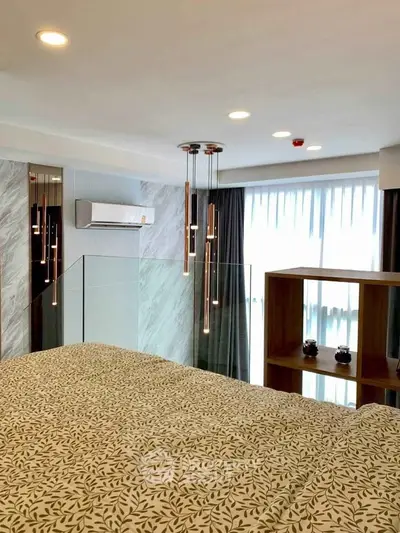 Modern bedroom with stylish lighting and large windows for natural light.