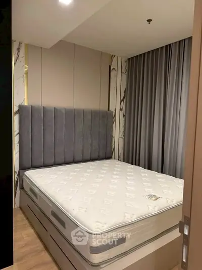 Modern bedroom with stylish headboard and comfortable mattress in a cozy setting.