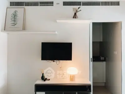 Modern living room with minimalist decor and wall-mounted TV