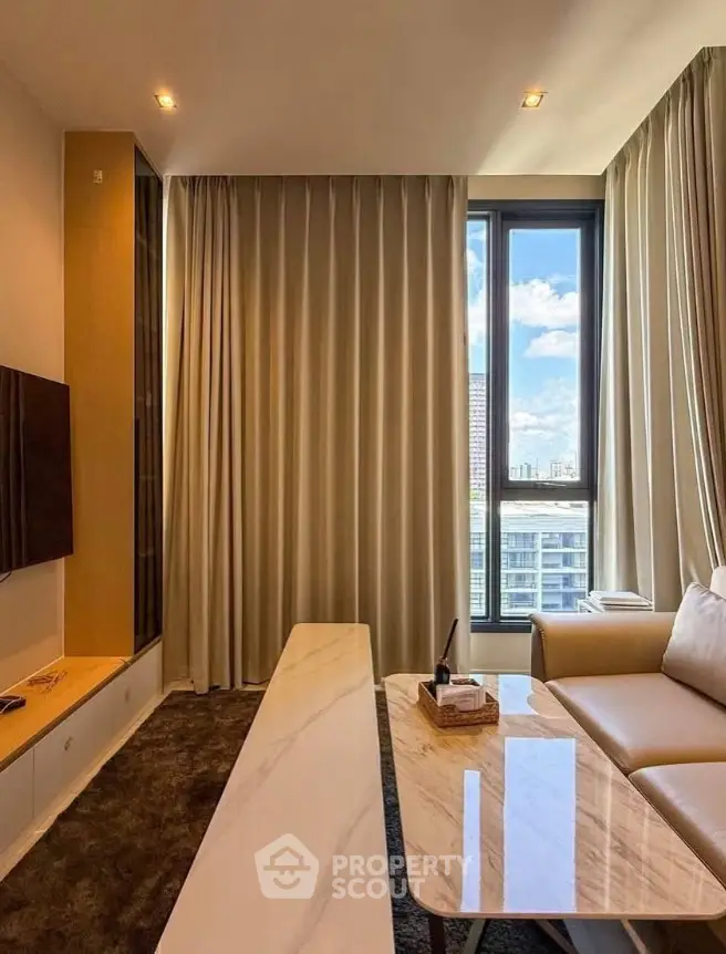 Luxurious living room with modern decor and stunning city view through large windows.