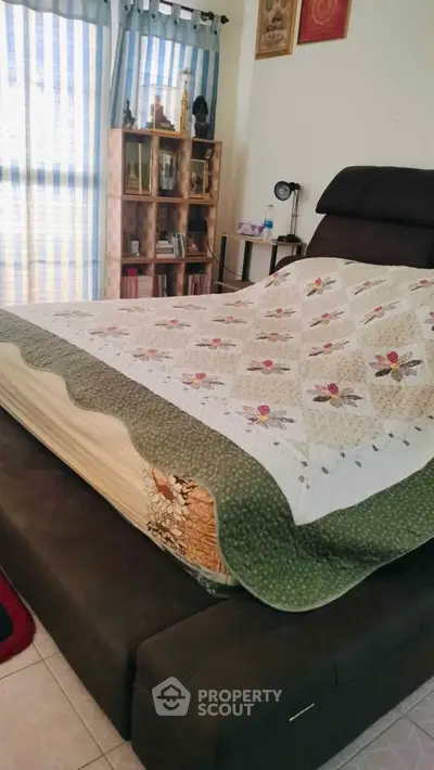 Cozy bedroom with stylish decor and natural light, featuring a comfortable bed and elegant furnishings.