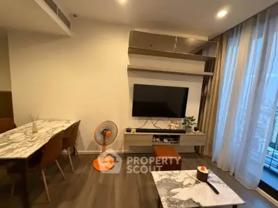 Modern living room with stylish furniture and city view, featuring a marble dining table and wall-mounted TV.