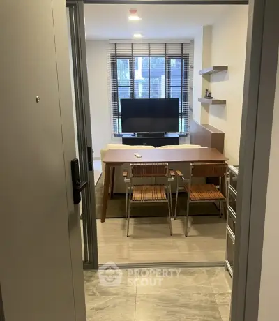 Modern living room with stylish furniture and large window, perfect for cozy urban living.