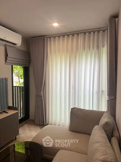 Cozy living room with large window and modern furnishings