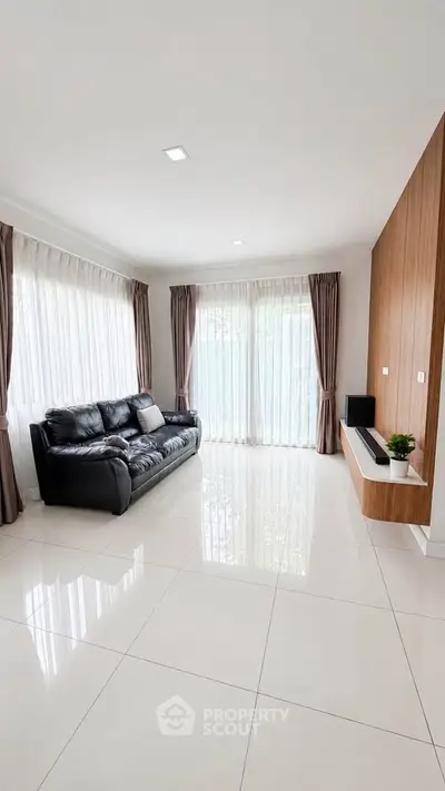 Spacious living room with modern decor and large windows for natural light.