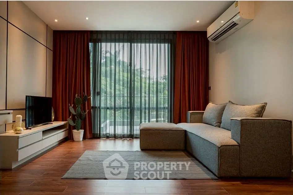 Stylish modern living room with large window and cozy sofa