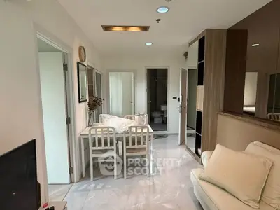 Modern living room with dining area and stylish decor in a cozy apartment.