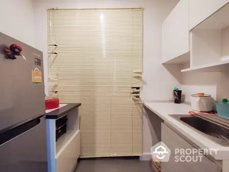 Modern kitchen with sleek cabinetry and stainless steel fridge