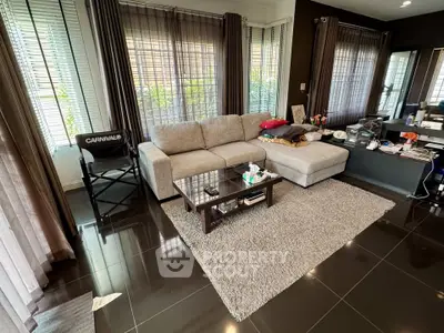 Spacious living room with modern furniture and large windows for natural light.