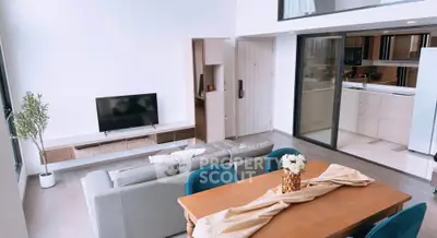 Spacious modern living room with open kitchen and elegant dining area, perfect for family gatherings.