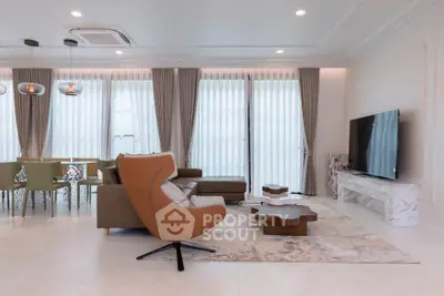 Luxurious modern living room with elegant furniture and large windows
