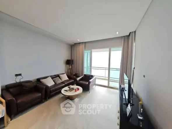 Spacious living room with modern furniture and balcony view