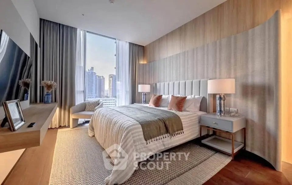 Luxurious bedroom with city view, elegant decor, and modern furnishings in high-rise apartment.