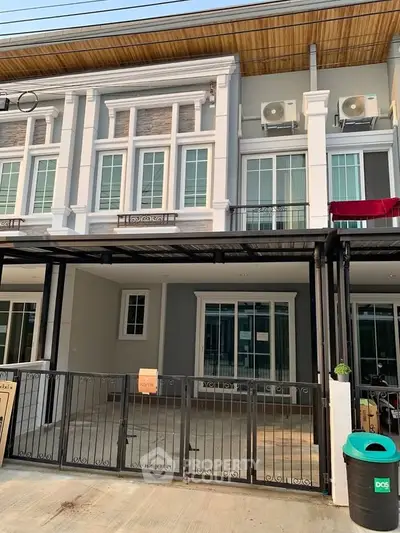 Modern townhouse exterior with gated parking and stylish facade