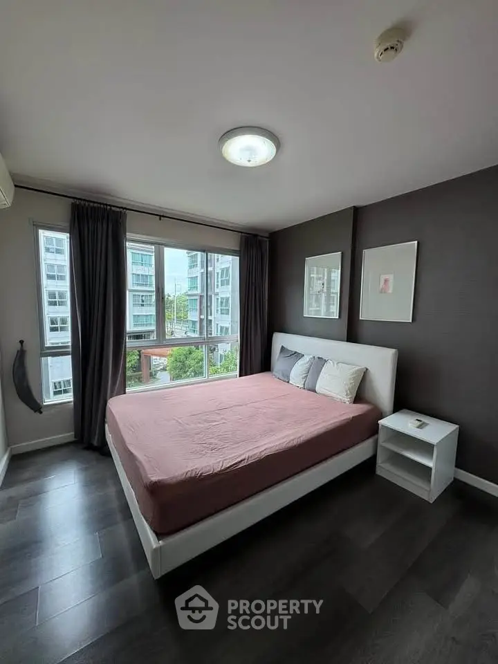 Modern bedroom with large windows and stylish decor in urban apartment