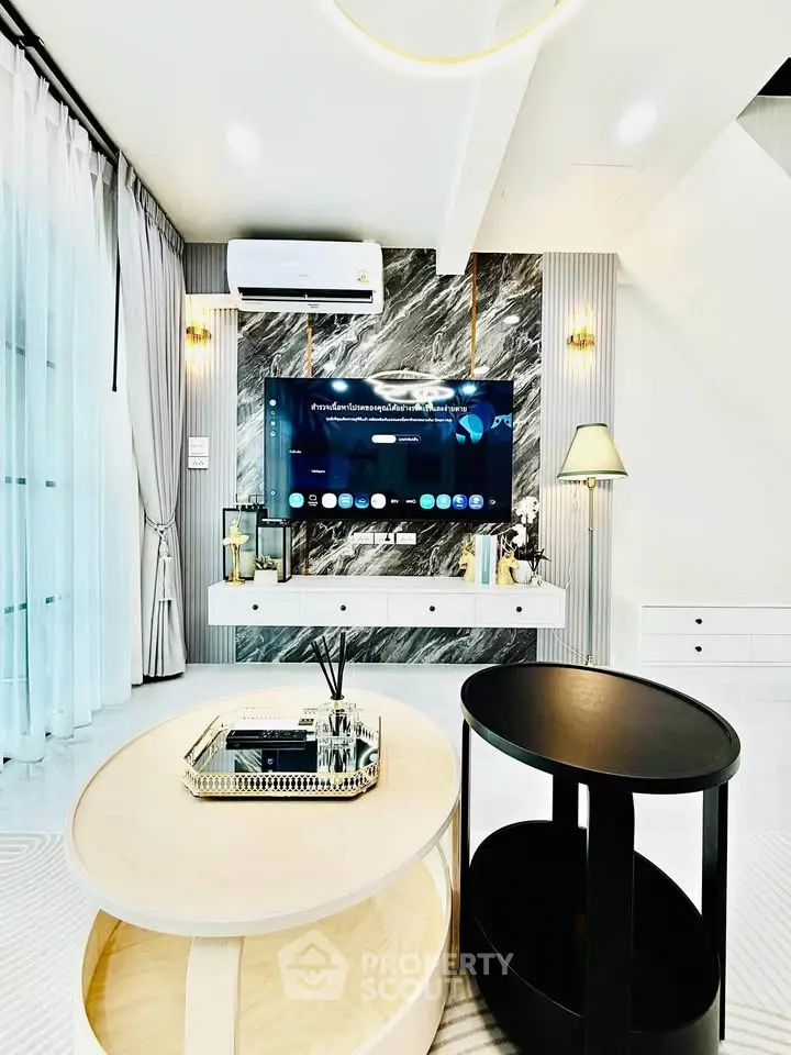 Luxurious modern living room with elegant decor and stylish furniture, featuring a sleek TV setup.