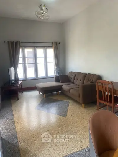 Cozy living room with modern furniture and large windows for natural light.