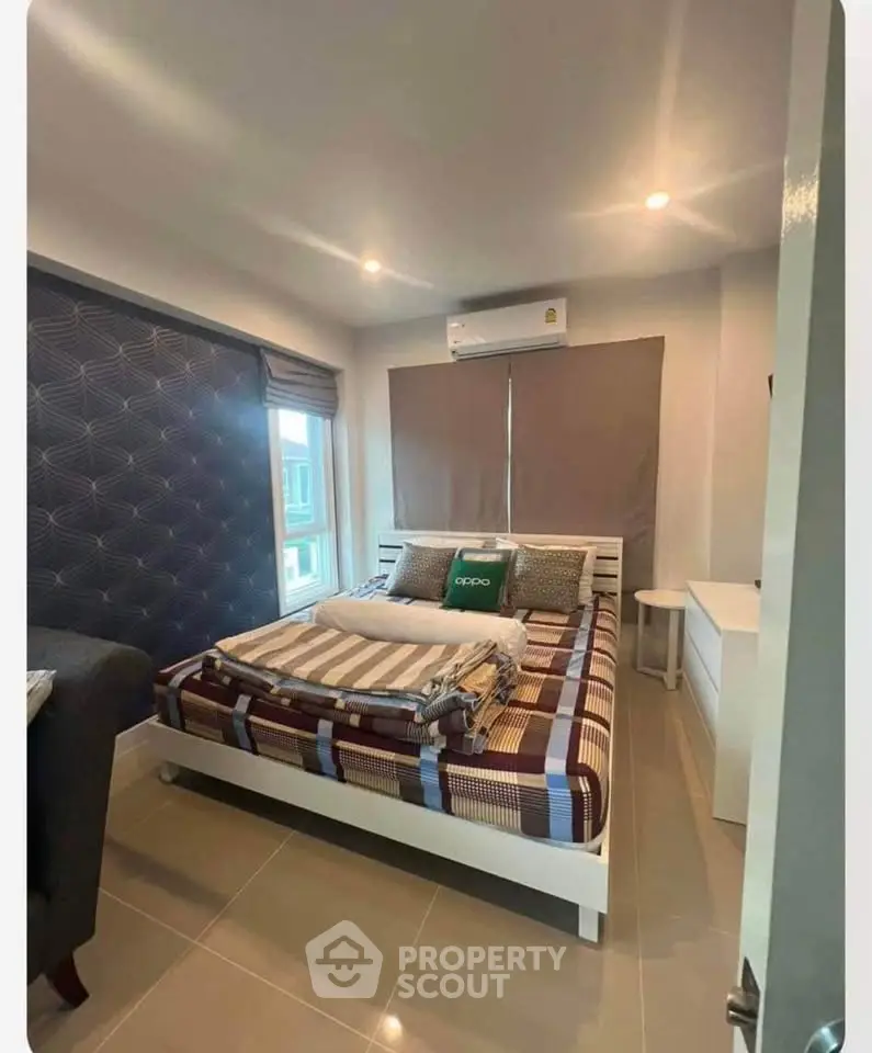 Cozy bedroom with modern decor and ample natural light, featuring a comfortable bed and stylish furnishings.