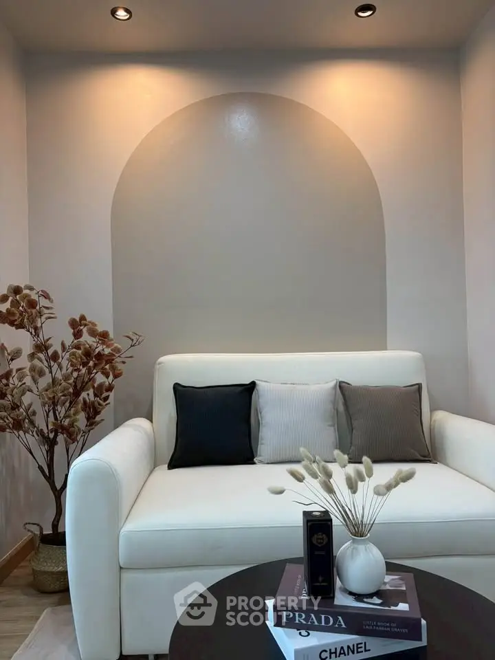 Stylish living room with modern decor and cozy white sofa, perfect for relaxation and comfort.