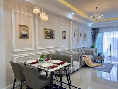 Luxurious open-concept living and dining area with elegant decor and modern lighting