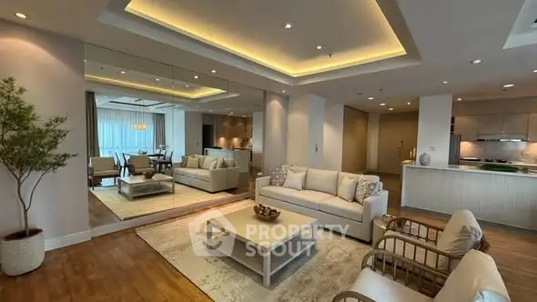 Luxurious open-plan living room with elegant decor and modern lighting