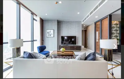 Luxurious modern living room with elegant decor and large windows offering stunning city views.