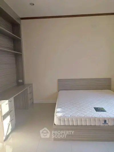 Modern bedroom with built-in shelving and sleek design