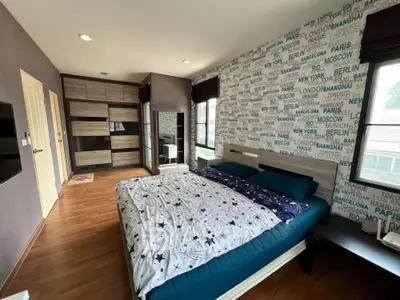 Stylish bedroom with modern decor and large wardrobe in a cozy apartment