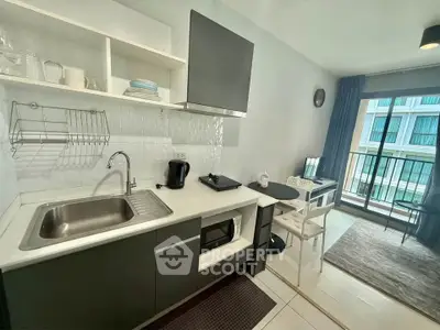 Modern kitchen with open layout and balcony view in stylish apartment
