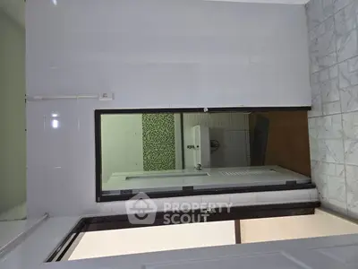Modern bathroom with tiled walls and sleek fixtures, perfect for a contemporary home.