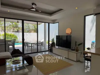 Spacious modern living room with pool view and stylish decor