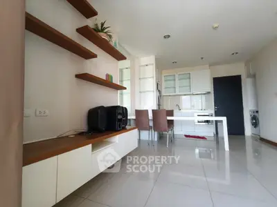 Modern open-layout living room with sleek kitchen and dining area