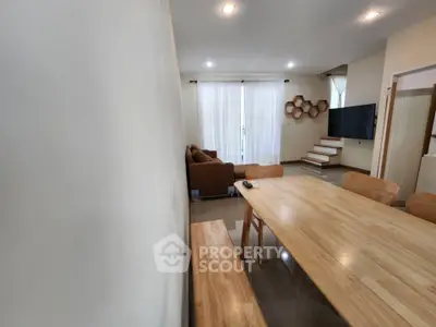 Modern living room with wooden dining table and cozy seating area