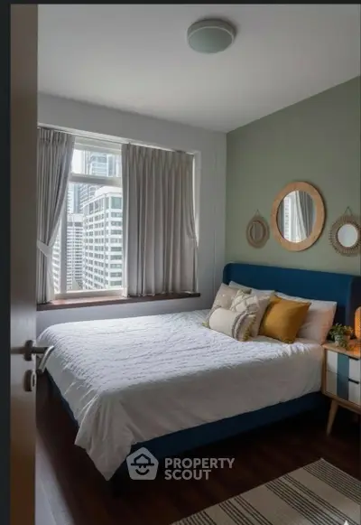 Cozy bedroom with city view, stylish decor, and natural light.