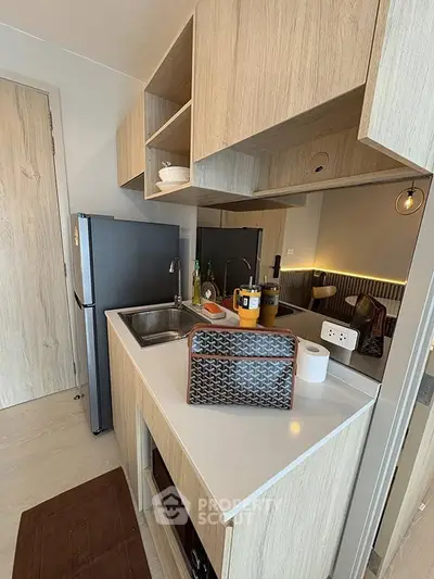 Modern compact kitchen with sleek cabinetry and stainless steel appliances