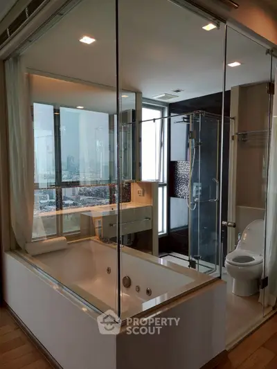 Luxurious bathroom with city view, featuring a modern bathtub and glass shower enclosure.