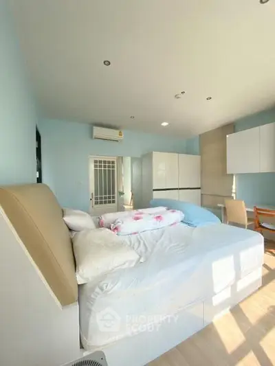 Bright and airy bedroom with modern furnishings and ample natural light
