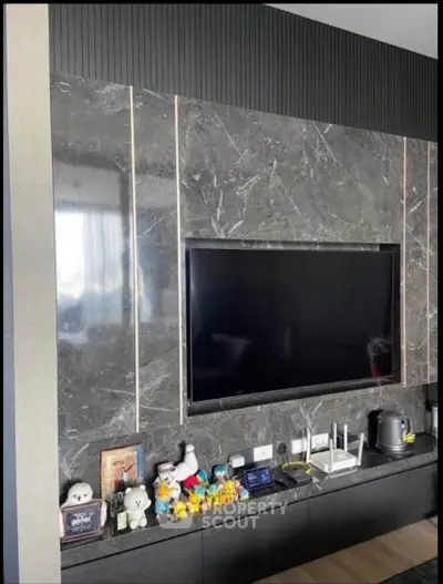 Modern living room with sleek marble TV wall and stylish decor