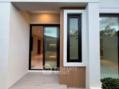 Modern entrance with sleek glass door and stylish window design