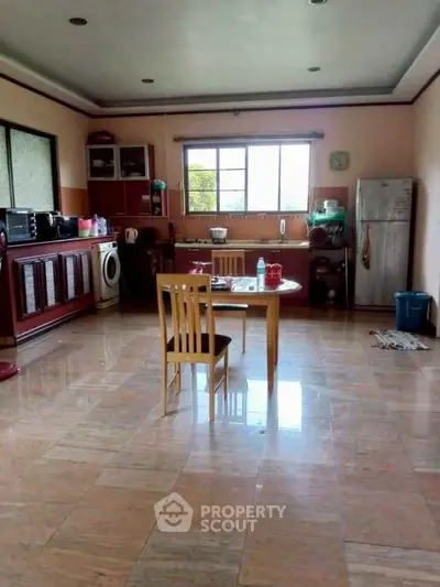 Spacious kitchen with open layout, featuring modern appliances and ample natural light.