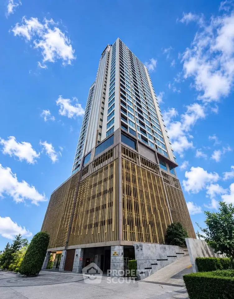 Stunning modern high-rise building with sleek architecture and lush greenery, perfect for urban living.
