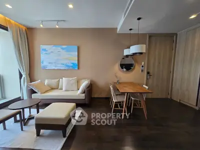 Modern living room with stylish decor and natural light, featuring a cozy sofa and elegant dining area.