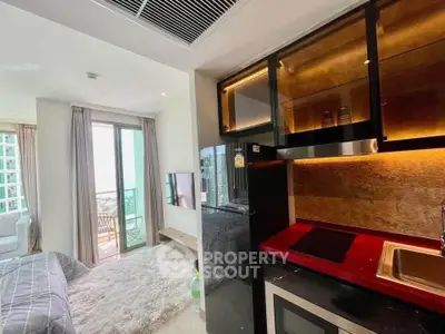 Modern studio apartment with open kitchen and balcony view